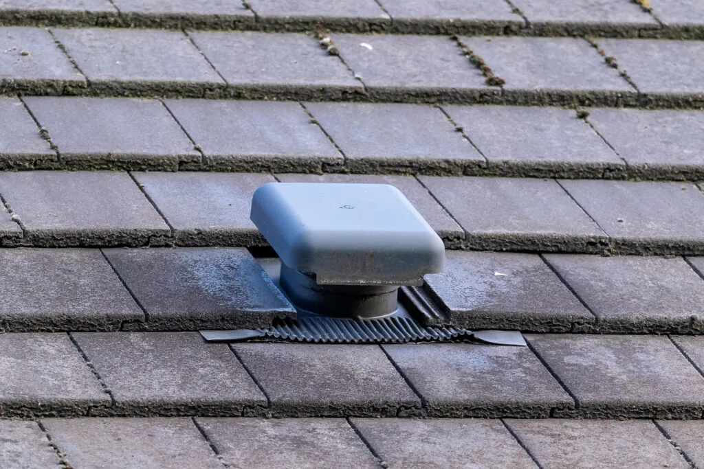 Close-up of a roof vent cap on a slate roof